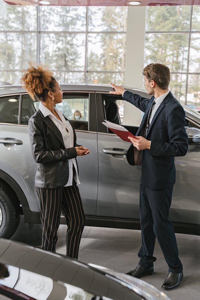Mastering the First Impression: Your intriguing post title goes here A woman and a car salesman discuss vehicle options inside a dealership.
